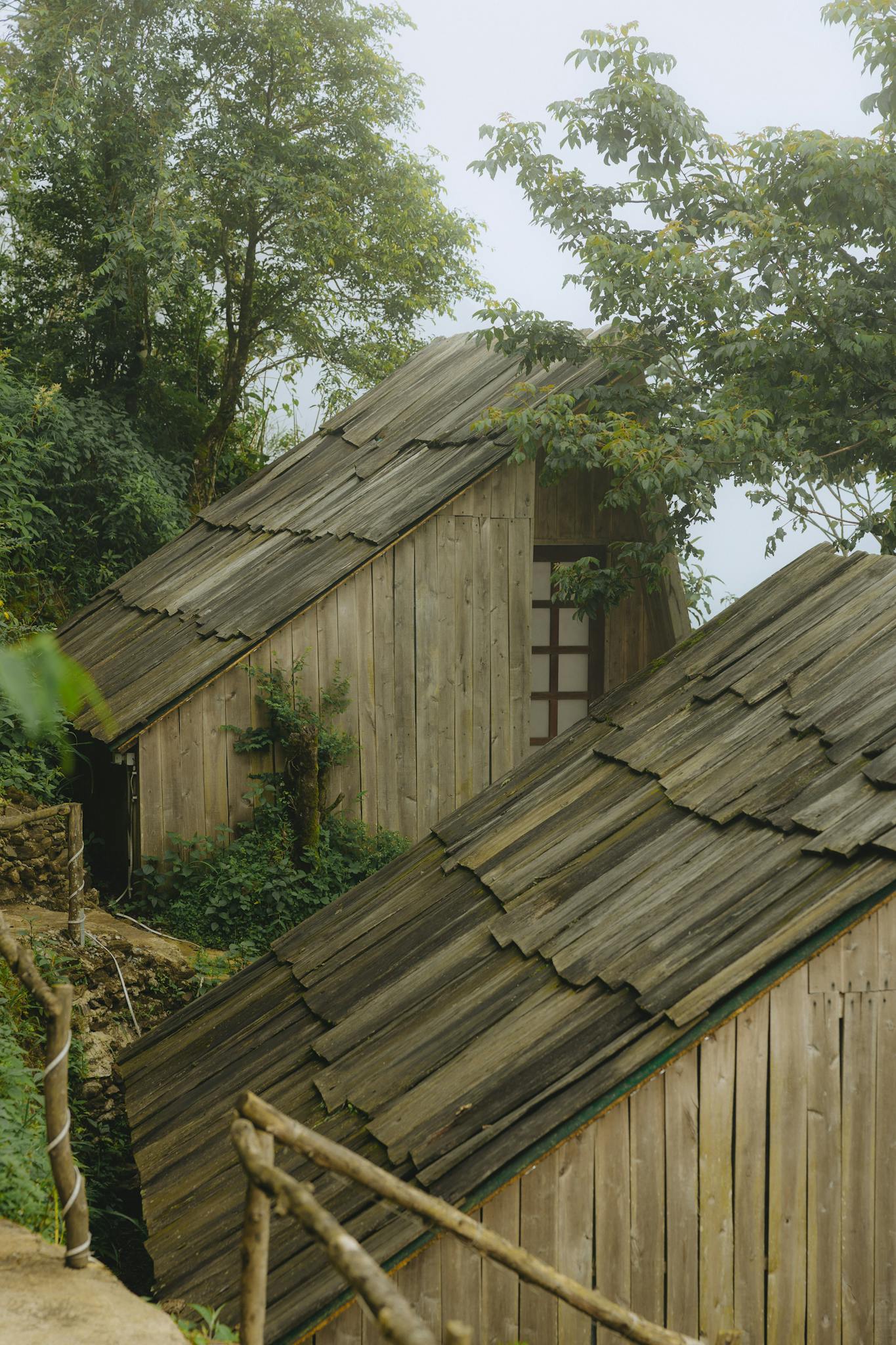 Two wooden houses with a roof made of wood